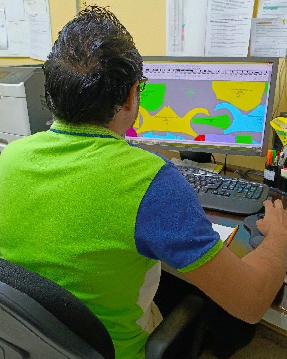 A technician working on an automated marker layout on screen.