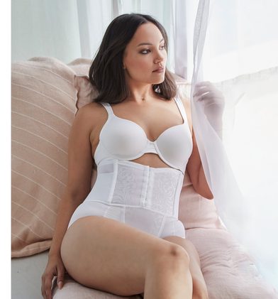 A white shapewear body briefer worn with a matching bra.